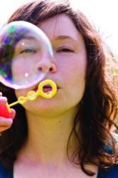 girl blowing bubbles